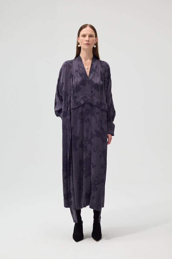 Woman wearing a dark floral dress on a white background